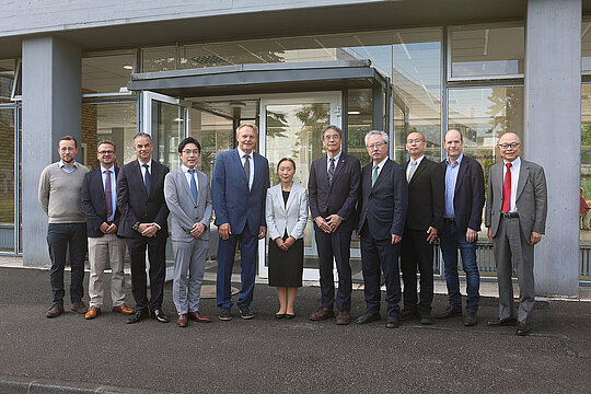 Gruppenfoto aller Teilnehmenden: Dr. med. Joscha Mulorz (UKD); Prof. Dr. med. Markus Wagenhäuser (UKD); Prof. Dr. med. Frederik Giesel (UKD); Prof. Tadashi Watabe (Universität Osaka); Prof. Dr. Hubert Schelzig (UKD); Frau Dr. Yuriko Mori (UKD); Prof. Takashi Nakano (Universität Osaka); Prof. Koichi Fukase (Universität Osaka); Prof. Takamazu Masayuki (Universität Osaka); Prof. Dr. Heiner Fangerau; Prof. Dr. Masahiko Hayashi (JSPS).