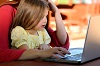 Mutter arbeitet mit Kind am Laptop